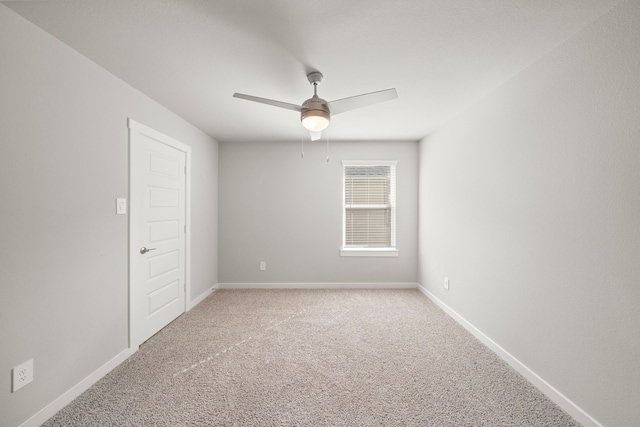 empty room with ceiling fan, baseboards, and carpet floors