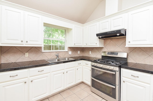 kitchen with a sink, under cabinet range hood, range with two ovens, white cabinets, and lofted ceiling