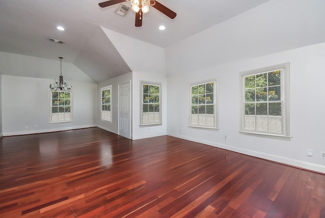unfurnished living room with dark wood finished floors, visible vents, ceiling fan with notable chandelier, and a healthy amount of sunlight
