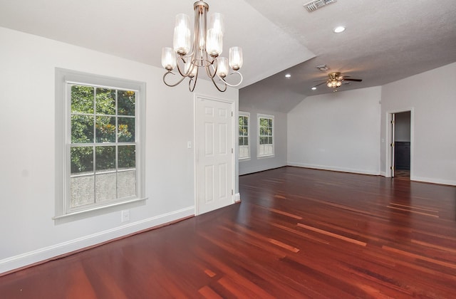 unfurnished dining area with visible vents, vaulted ceiling, baseboards, wood finished floors, and ceiling fan with notable chandelier