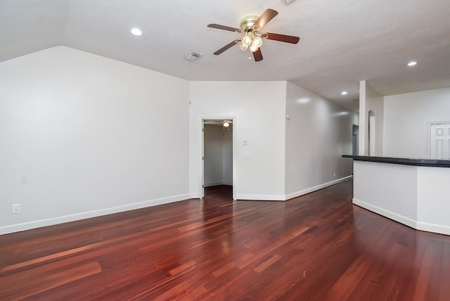 unfurnished room featuring wood finished floors, visible vents, a ceiling fan, and baseboards