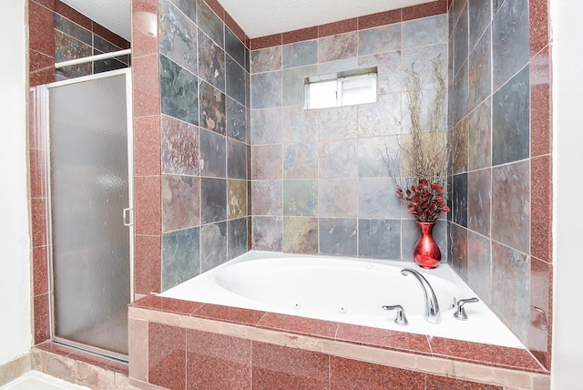 bathroom featuring a stall shower and a bath