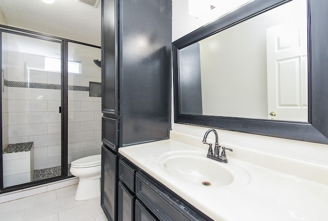 bathroom with a stall shower, toilet, tile patterned flooring, and vanity