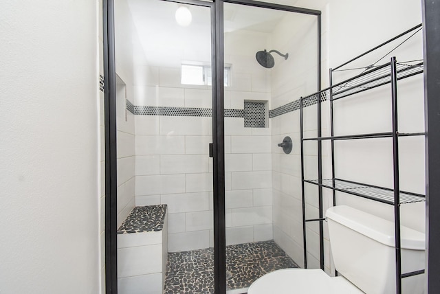 full bath featuring toilet and a stall shower