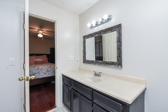 ensuite bathroom with connected bathroom, ceiling fan, and vanity