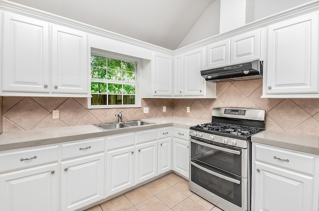 1802 Terry St, Houston, TX 77009 - kitchen featuring range with two ovens, under cabinet range hood, light countertops, vaulted ceiling, and light tile patterned floors