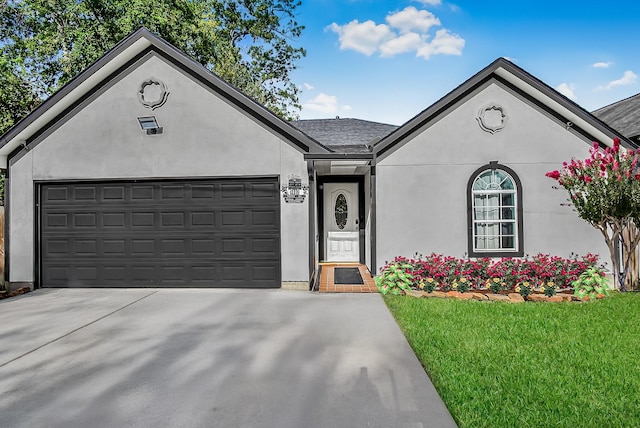 1802 Terry St, Houston, TX 77009 - single story home featuring driveway, stucco siding, an attached garage, and a front lawn
