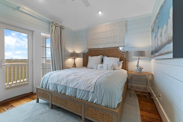 bedroom featuring recessed lighting, wood finished floors, access to outside, ceiling fan, and wooden walls