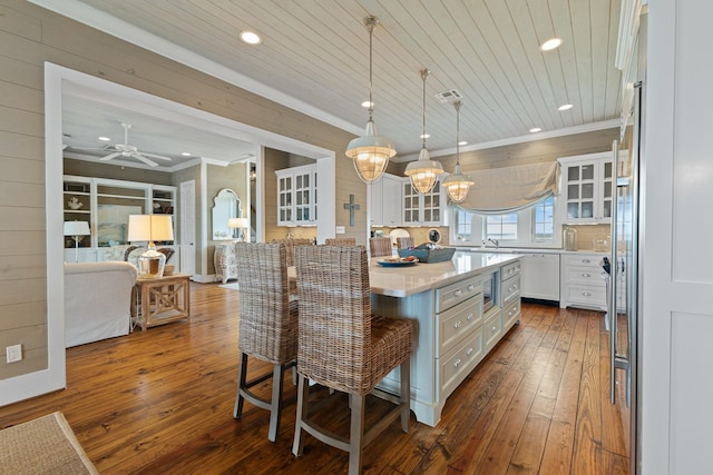 kitchen featuring dark wood-type flooring, recessed lighting, ornamental molding, and white cabinets