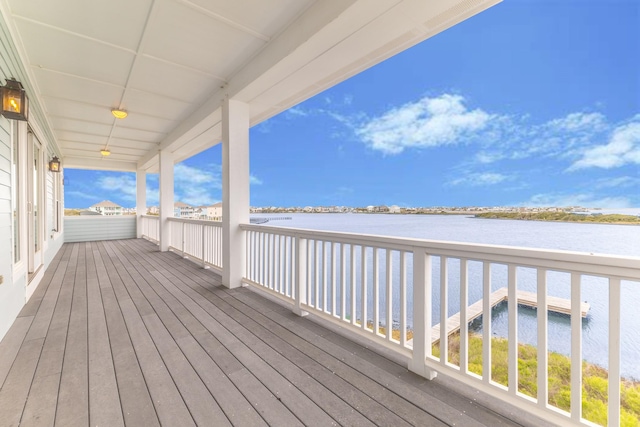 wooden terrace featuring a water view