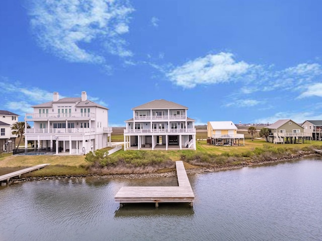 dock area with a lawn and a water view