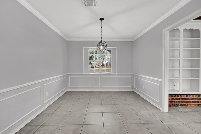 unfurnished dining area with ornamental molding, a wainscoted wall, visible vents, and light tile patterned floors