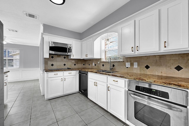 kitchen with black appliances, visible vents, white cabinetry, and a sink