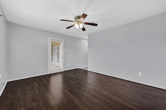 spare room with a ceiling fan, wood finished floors, and baseboards
