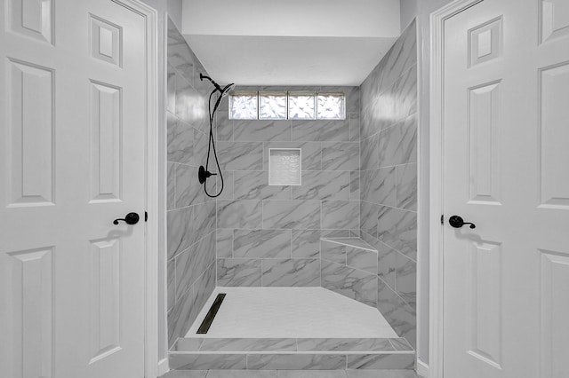 bathroom with tiled shower