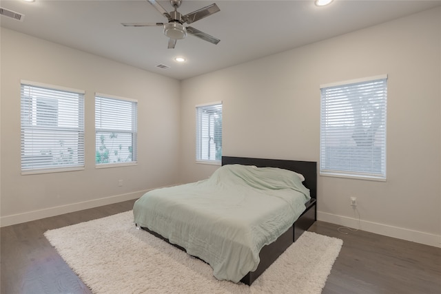 bedroom with baseboards, visible vents, dark wood finished floors, and recessed lighting
