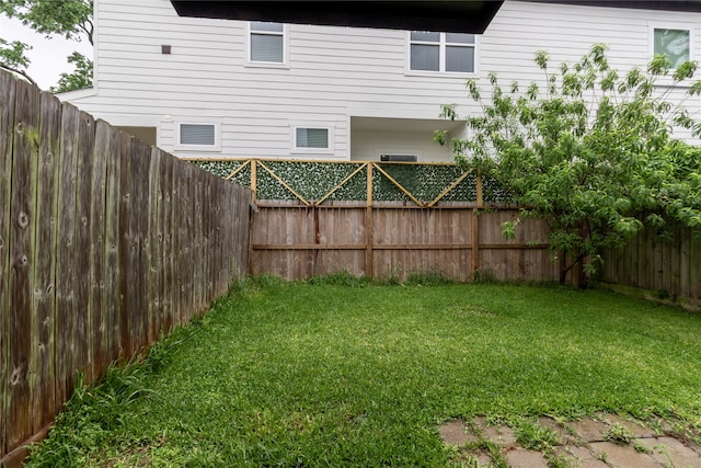 view of yard with a fenced backyard