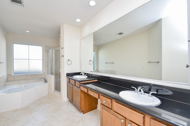 full bath featuring a sink, a stall shower, visible vents, double vanity, and tile patterned flooring