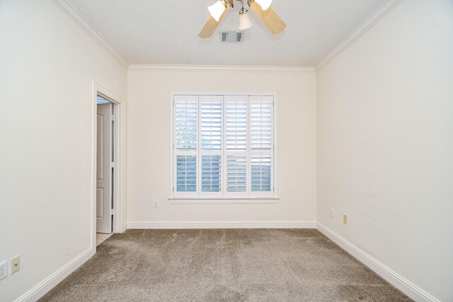 unfurnished room featuring visible vents, ornamental molding, ceiling fan, and carpet