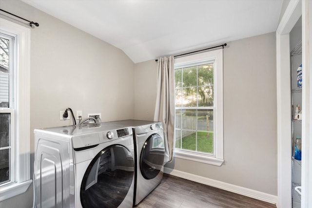 washroom featuring baseboards, wood finished floors, laundry area, and washer and clothes dryer