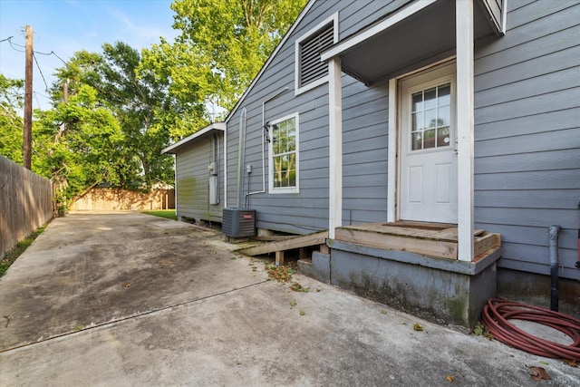 exterior space with fence, a patio area, and central AC