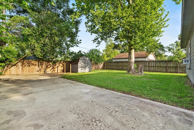 view of yard featuring an outdoor structure, a patio, a shed, and a fenced backyard