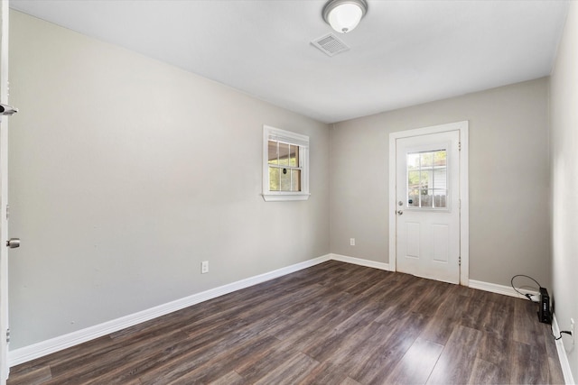 entrance foyer featuring dark wood-style flooring, visible vents, and baseboards
