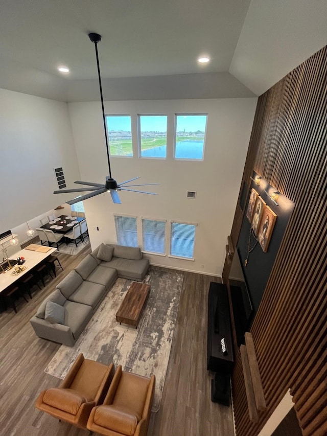 living area with wood finished floors, ceiling fan, recessed lighting, and visible vents