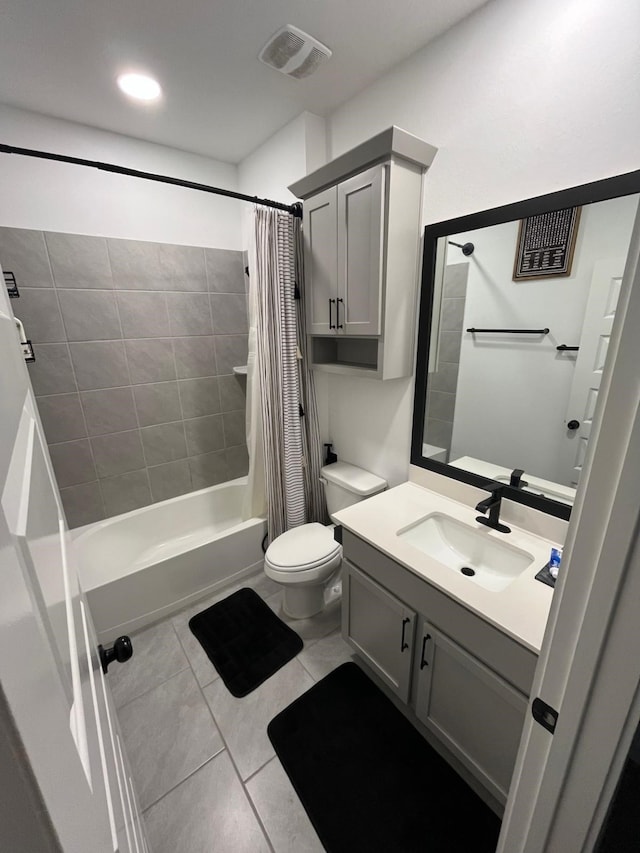 full bathroom with visible vents, shower / tub combo with curtain, toilet, tile patterned floors, and vanity