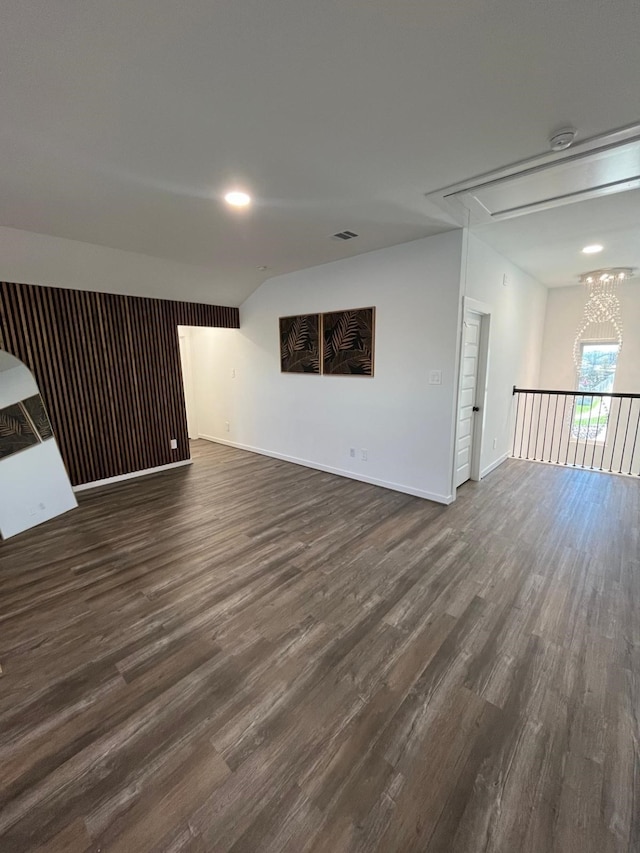 interior space with attic access, visible vents, baseboards, and dark wood-type flooring