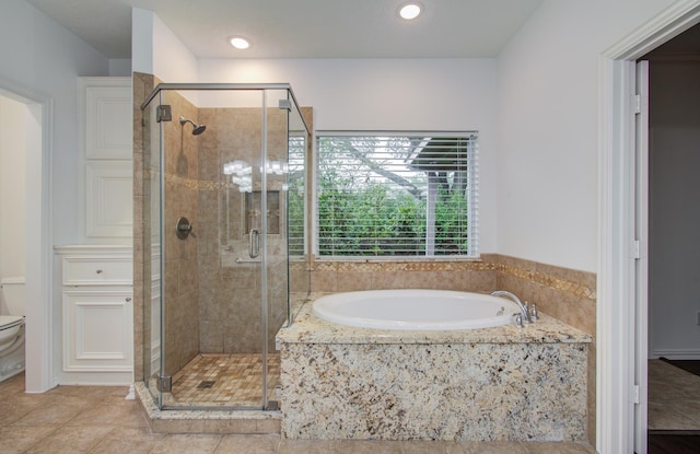 7203 W Hearthstone Green Dr, Houston, TX 77095 - bathroom with a bath, a shower stall, toilet, recessed lighting, and tile patterned flooring