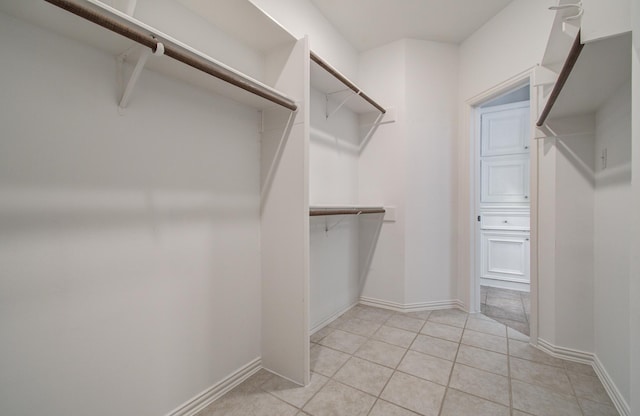 7203 W Hearthstone Green Dr, Houston, TX 77095 - spacious closet featuring light tile patterned flooring