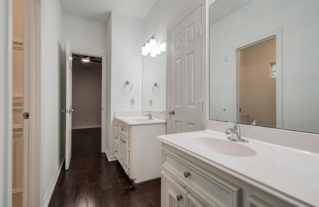 7203 W Hearthstone Green Dr, Houston, TX 77095 - bathroom featuring two vanities, wood finished floors, and toilet