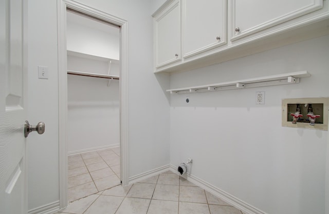 7203 W Hearthstone Green Dr, Houston, TX 77095 - washroom with cabinet space, hookup for a washing machine, light tile patterned floors, and baseboards