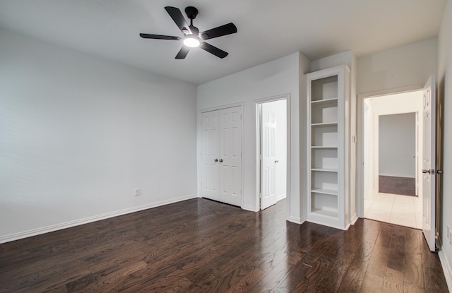 7203 W Hearthstone Green Dr, Houston, TX 77095 - unfurnished bedroom with dark wood-style floors, baseboards, and a ceiling fan
