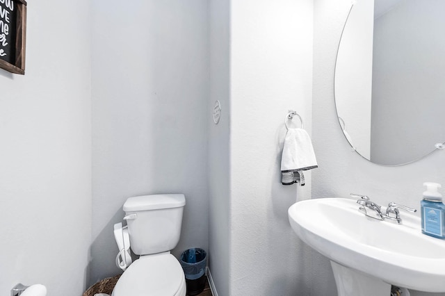 half bath with toilet and a sink