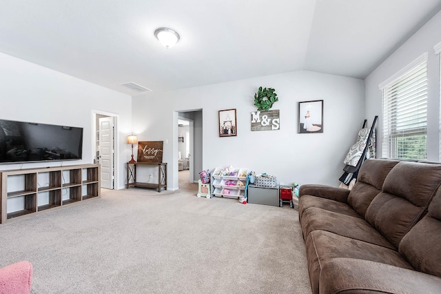 carpeted living area featuring visible vents and vaulted ceiling