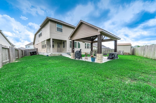 back of property featuring a fenced backyard, a yard, and a patio area