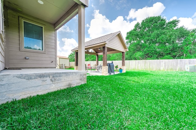 view of yard featuring a gazebo, a fenced backyard, and a patio area