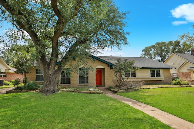 single story home featuring brick siding, central AC unit, and a front lawn