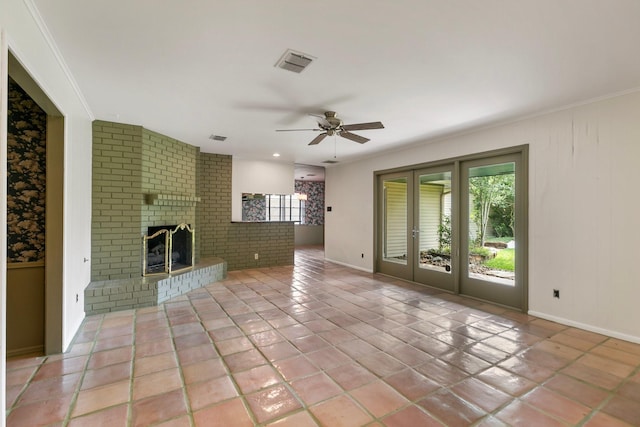 unfurnished living room featuring baseboards, a ceiling fan, a brick fireplace, and visible vents