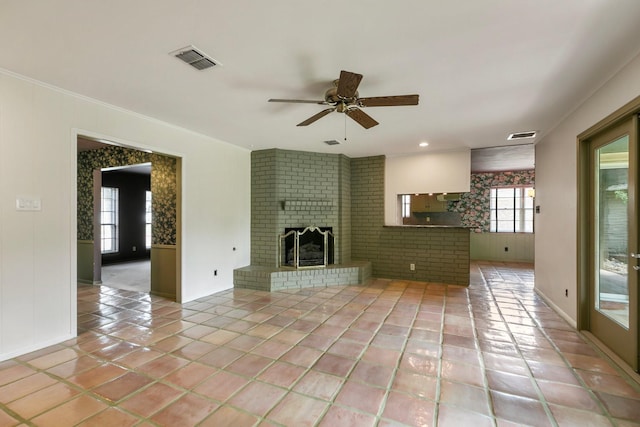 unfurnished living room with ceiling fan, visible vents, a fireplace, baseboards, and light tile patterned flooring