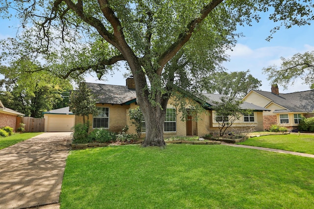 ranch-style house featuring brick siding, fence, a front yard, and concrete driveway