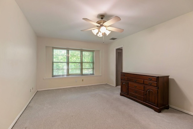 unfurnished bedroom featuring visible vents, baseboards, and light carpet