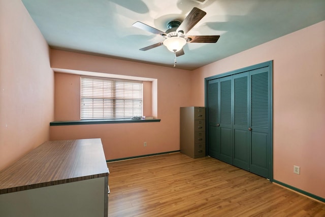 unfurnished bedroom with a closet, a ceiling fan, and light wood-style floors