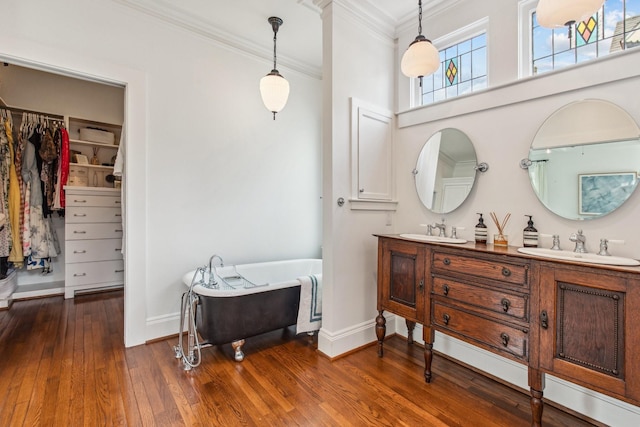 1202 Ashland St, Houston, TX 77008 - full bathroom with ornamental molding, double vanity, a soaking tub, hardwood / wood-style floors, and baseboards
