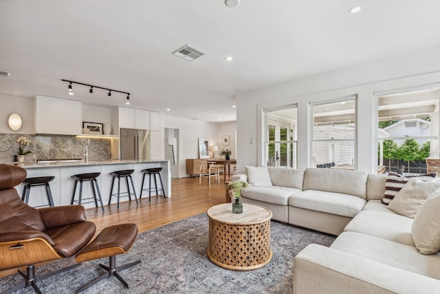1202 Ashland St, Houston, TX 77008 - living room with light wood finished floors, rail lighting, and recessed lighting