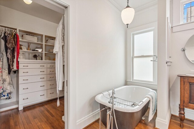 1202 Ashland St, Houston, TX 77008 - full bathroom with wood finished floors, baseboards, a freestanding bath, and crown molding