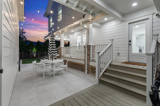 1202 Ashland St, Houston, TX 77008 - deck at dusk featuring outdoor dining area, fence, and a patio