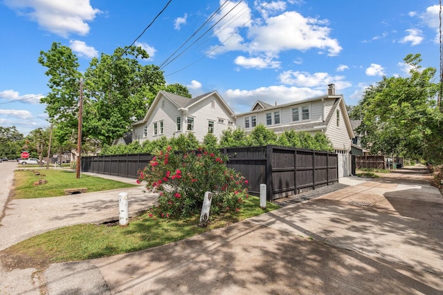 1202 Ashland St, Houston, TX 77008 - view of home's exterior with fence and a chimney